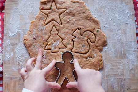 Child hands making from dough gingerbread manの写真素材