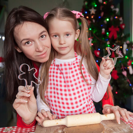 Happy family in Santa hats baking Christmas gingerbread cookies togetherの写真素材