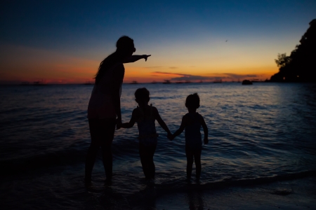 Family of three silhouette in the sunset on Boracay beachの写真素材
