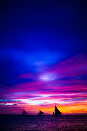 Incredible beautiful sunset with sailboat on the horizon in Boracay islandの写真素材