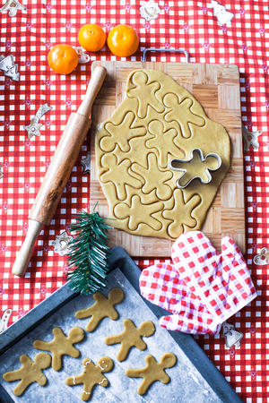 Cutting the gingerbread cookie dough for Christmas and New Yearの写真素材