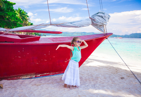 Beautiful little girl having fun on an exotic beachの写真素材