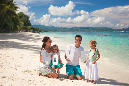 Young family and two kids with word LOVE on tropical vacationの写真素材