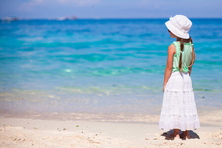 Adorable little girl walking on tropical white beachの写真素材