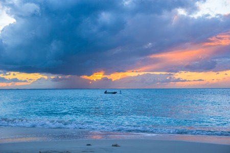 Sailing boat to the sunset in Providenciales island on Turks and Caicosの写真素材