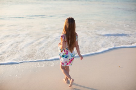Adorable little girl at beach during summer vacationの写真素材