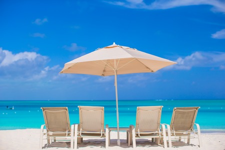 White umbrella at tropical beach background blue seaの写真素材
