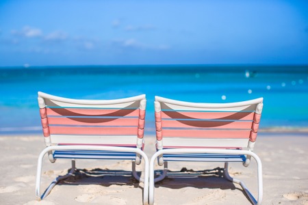 Two beach loungers on exotic resort on white sand beachの写真素材