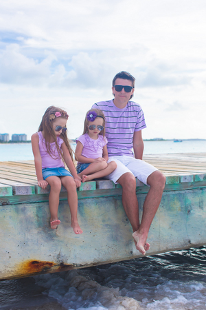 Family on wooden dock enjoying ocean viewの写真素材