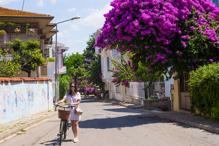 Beautiful pretty woman on bicycle in summer vacationの写真素材