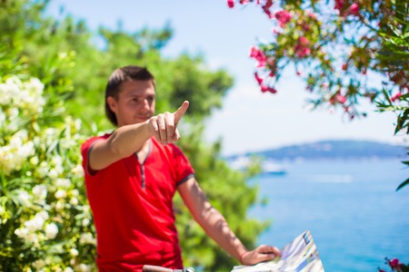 Young traveling man with map of the islandの写真素材