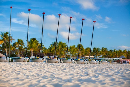Group of catamarans with colorful sails on exotic Caribbean beachの写真素材