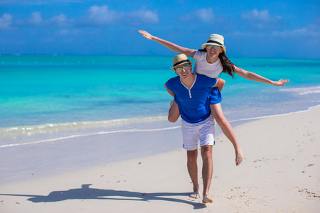 Young couple have fun on white sandy beachの写真素材