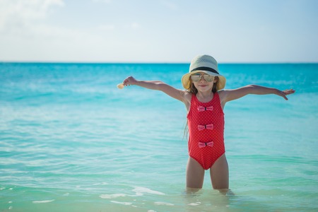 Cute little girl in hat at beach during summer vacationの写真素材