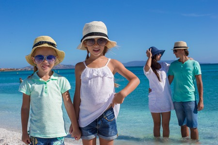Young beautiful family with two kids on tropical vacationの写真素材