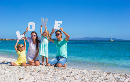 Young beautiful family with two kids on tropical vacationの写真素材