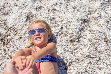 Adorable little girl at tropical beach during summer vacationの写真素材
