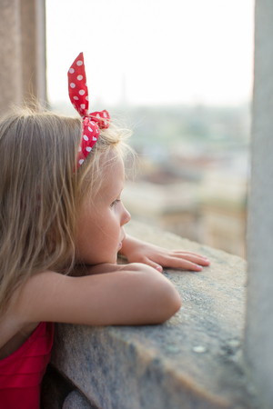 Adorable little girl on the rooftop of Duomo, Milan, Italyの写真素材