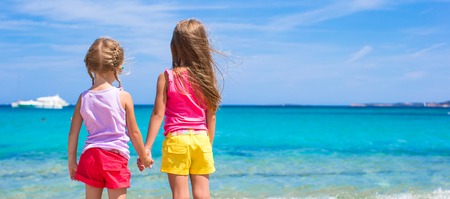 Adorable little girls at beach during summer vacationの写真素材