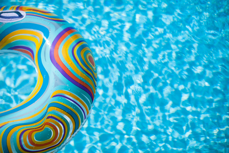 Colorful pool float in blue swimming basinの写真素材