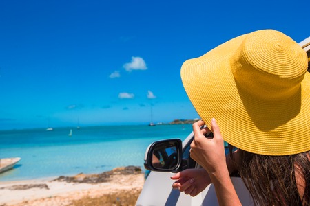 Young woman peeking out of the carの写真素材