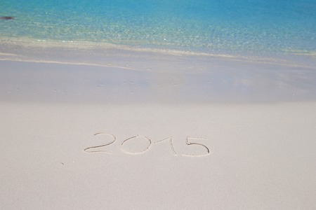 Merry Christmas written on tropical beach white sand with red xmas hatの写真素材