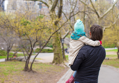 Young father and little daughter for a walk in Central Parkの写真素材