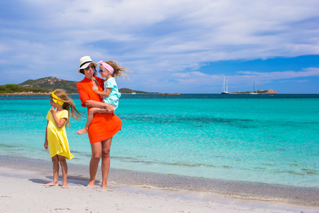 Mother and two kids at beach on sunny dayの写真素材