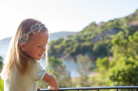 Adorable little girl on the balcony in exotic resortの写真素材