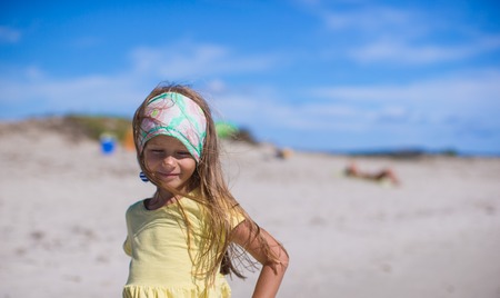 Adorable little girl have fun at tropical beach during vacationの写真素材