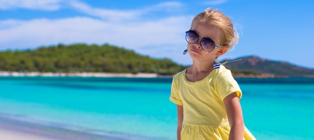 Adorable little girl have fun at tropical beach during vacationの写真素材