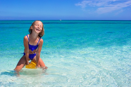 Little cute girl have fun at tropical beach during vacationの写真素材