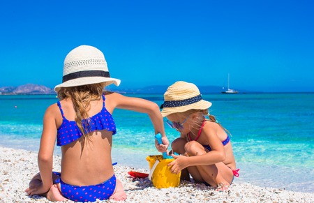 Little adorable girls playing with beach toys during vacationの写真素材