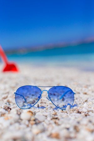 Close up of colorful blue sunglasses on tropical beachの写真素材