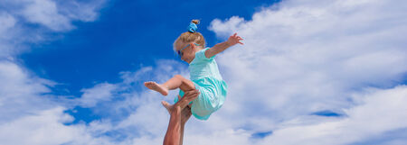 Young father and little daughter have fun during tropical beach vacationの写真素材