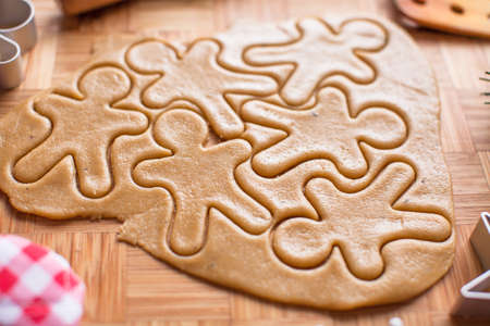 Cutting the gingerbread cookie dough for Christmas and New Yearの写真素材