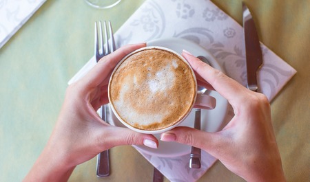Delicious, aromatic cappuccino for breakfast at a cafe in the resortの写真素材