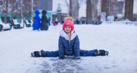 Adorable little girl outdoor in the park on winter dayの写真素材