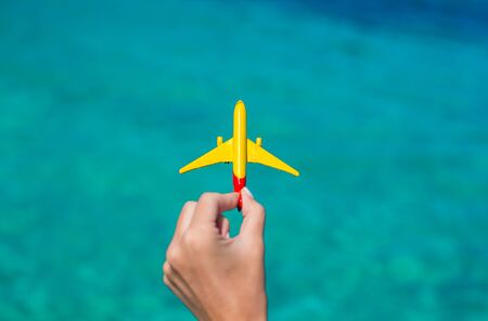 Small homemade plane on background of turquoise seaの写真素材