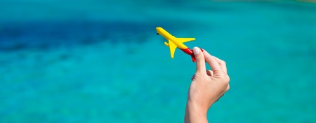 Small homemade plane on background of turquoise seaの写真素材