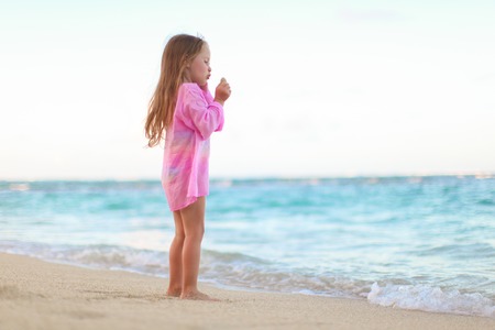 Adorable little girl having fun during tropical vacationの写真素材