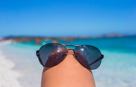 Close up of sunglasses on tropical beachの写真素材