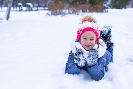 Adorable little girl outdoor in the park on winter dayの写真素材