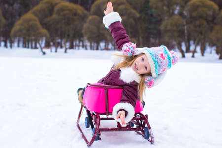 Adorable little happy girl have fun during winter vacation