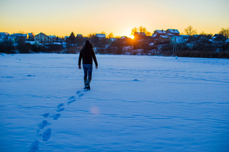 Man walking on deep snowy fieldの写真素材