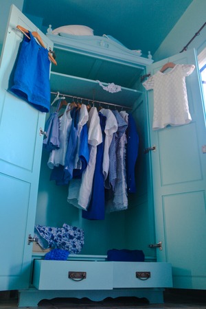 Dressing closet with blue clothes in the closetの写真素材