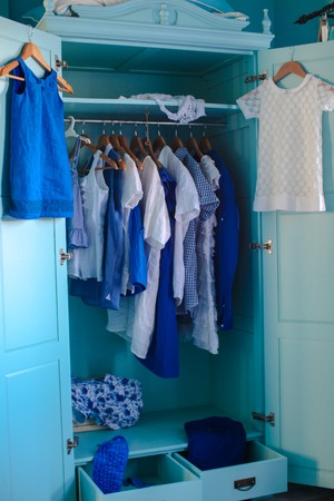 Dressing closet with blue clothes in the closetの写真素材