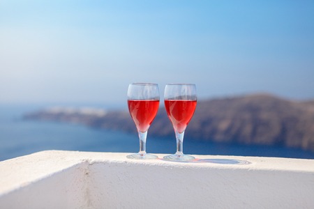 Two glasses of tasty red wine at sunset in Greeceの写真素材
