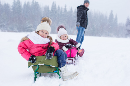 Happy family in winter outdoorsの写真素材