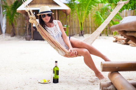 Young woman enjoying a sunny day in the hammockの写真素材